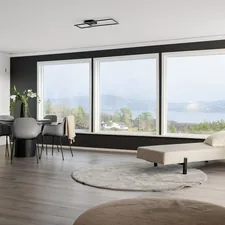 A living room with a couch a chair and a large window related to Elevate Your Windows with Stylish Valances for Sale