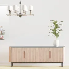 a living room with a couch, a chair and a potted plant related to Elevate Your Dining Space with Modern Sideboards and Buffets