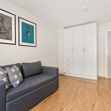 A living room with a couch and pictures on the wall related to The Ultimate Guide to Pull Out Couch Beds