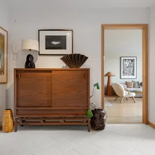 A living room with a dresser and a mirror related to Art Deco Sideboard - Timeless Masterpiece