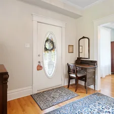 a living room with a piano and a mirror related to Maximizing Space: The Power of a Small Entryway Bench