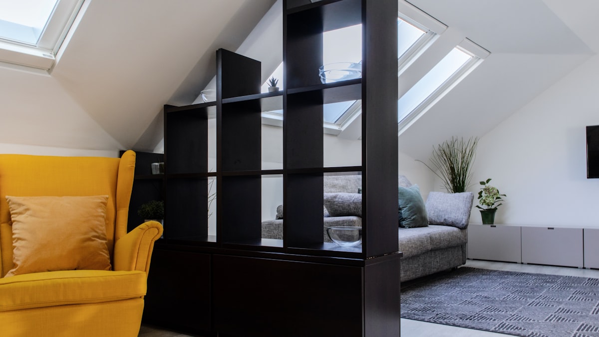 a living room with a yellow chair and a flat screen tv related to Maximizing Utility with the F150 Bed Divider