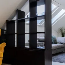 a living room with a yellow chair and a flat screen tv related to Maximizing Utility with the F150 Bed Divider