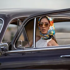 A look from the 1950's, a woman looks out of her vintage german auto. related to Elegant Touches: Scarf Window Valance Ideas