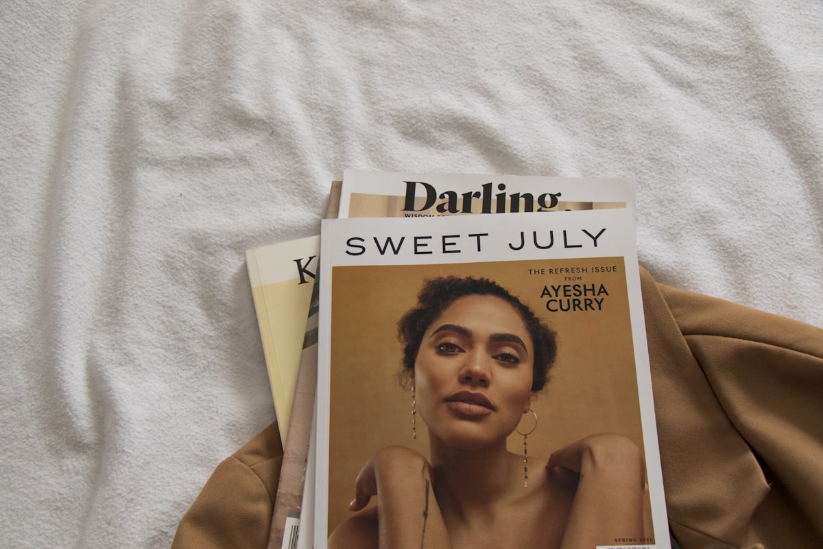 a magazine sitting on top of a bed next to a pair of scissors related to Matelasse Coverlet Queen: A Comprehensive Guide