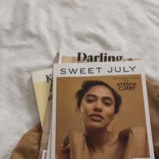 a magazine sitting on top of a bed next to a pair of scissors related to Matelasse Coverlet Queen: A Comprehensive Guide