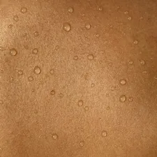 A man's back with water drops on it related to Understanding and Managing Heat Rash from Tanning Beds