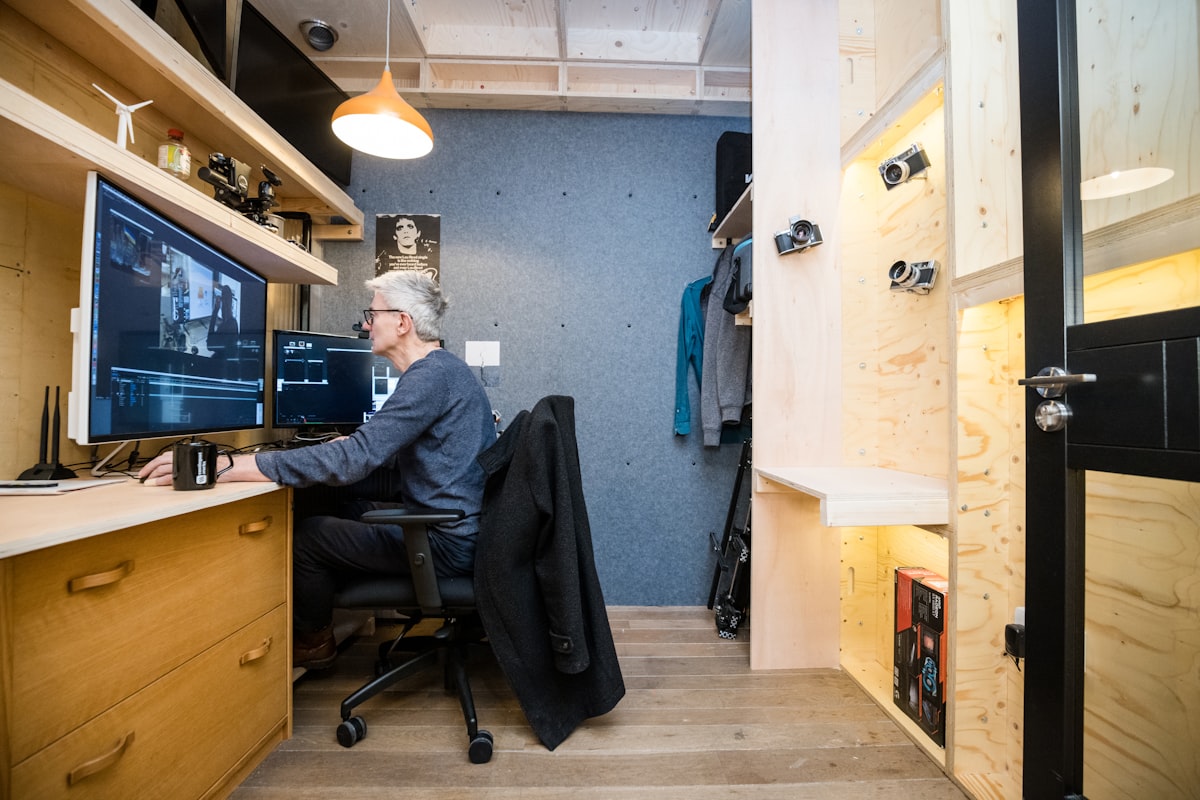 a man sitting at a desk in front of a computer related to Transform Your Space with the Versatile Ashley Sofa Bed