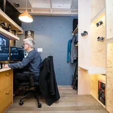 a man sitting at a desk in front of a computer related to Transform Your Space with the Versatile Ashley Sofa Bed