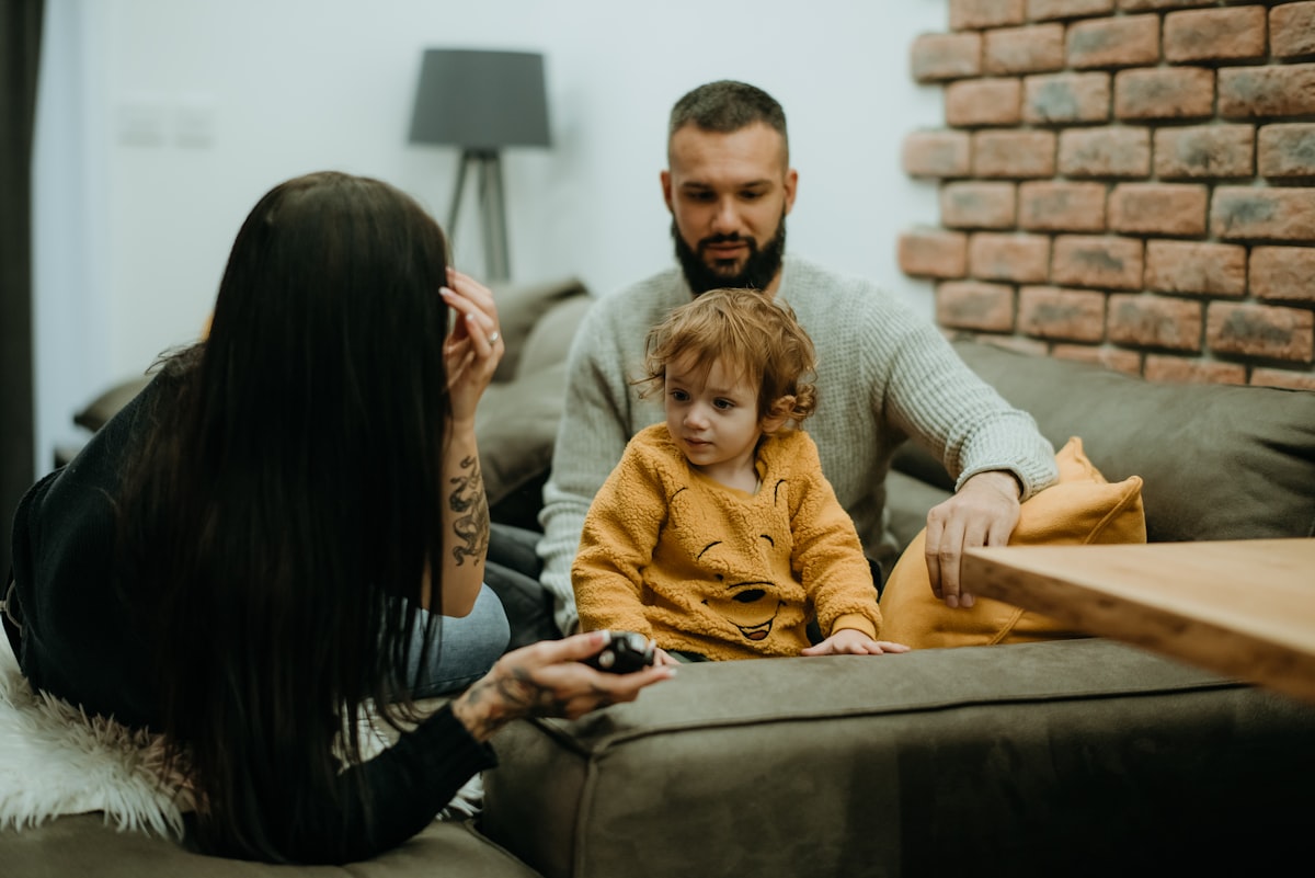 a man sitting on a couch next to a little girl related to Transform Your Home with Family Dollar Bedding: Affordable Comfort for Every Room