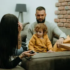 a man sitting on a couch next to a little girl related to Transform Your Home with Family Dollar Bedding: Affordable Comfort for Every Room