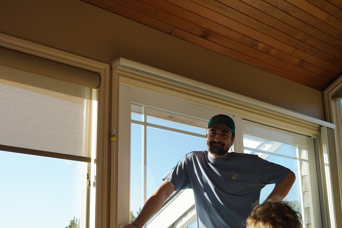 a man standing in front of a window next to a little girl related to Elevate Your Window Style with Wooden Window Valances