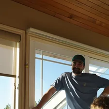 a man standing in front of a window next to a little girl related to Elevate Your Window Style with Wooden Window Valances