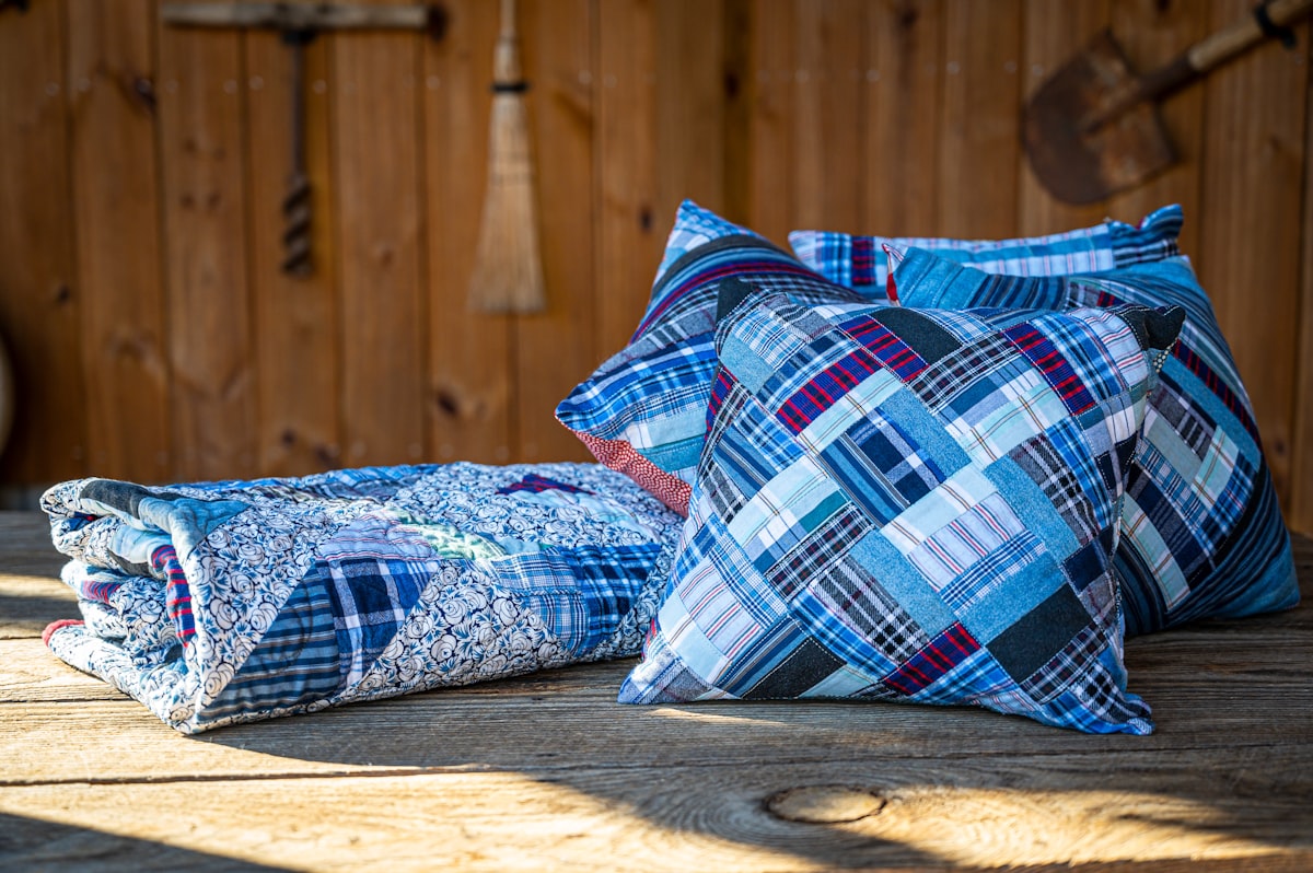 A memory quilt crafted from old shirts. related to Aqua Quilts Coverlets