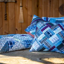 A memory quilt crafted from old shirts. related to Aqua Quilts Coverlets