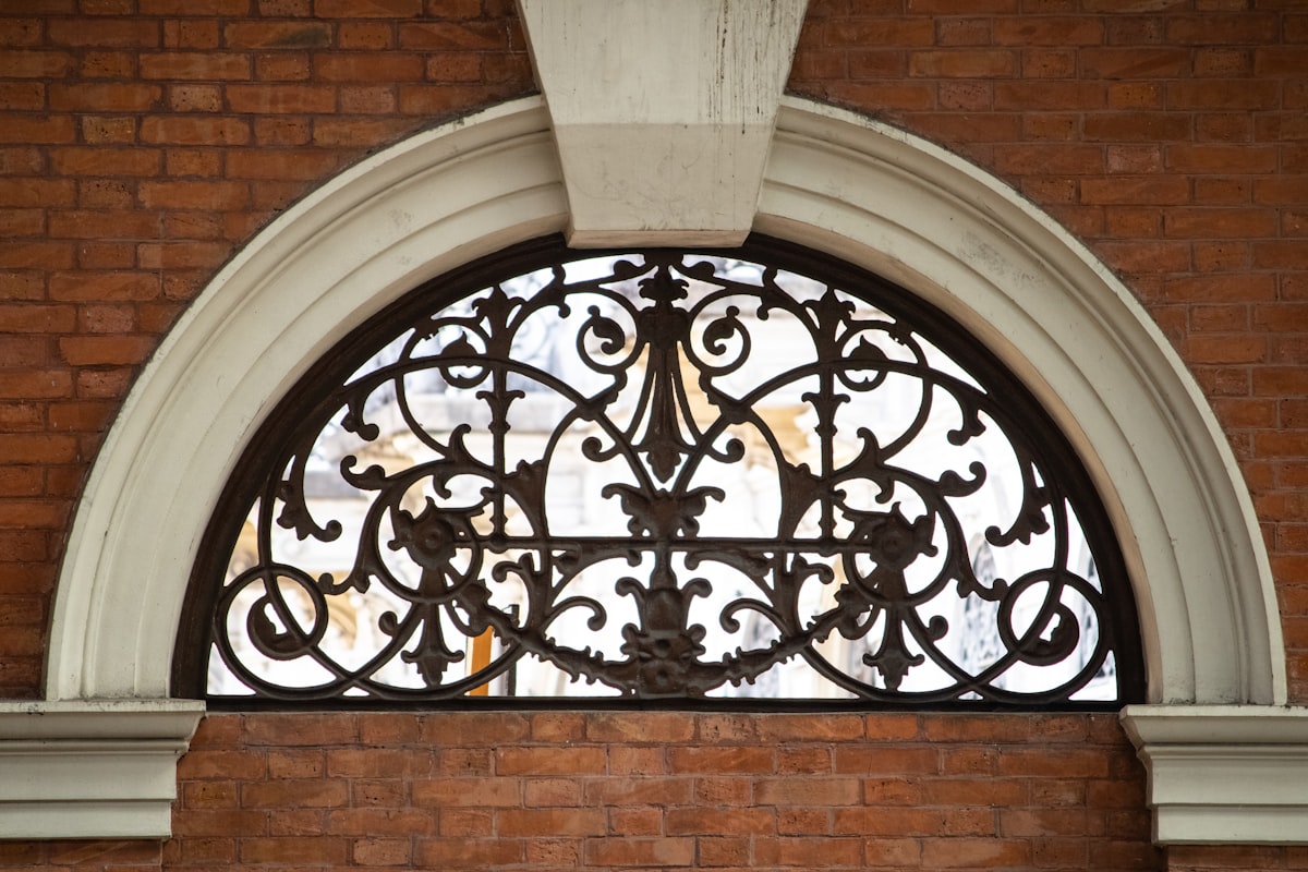 a metal gate on a building related to Elegant Arched Window Valances