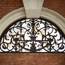 a metal gate on a building related to Elegant Arched Window Valances