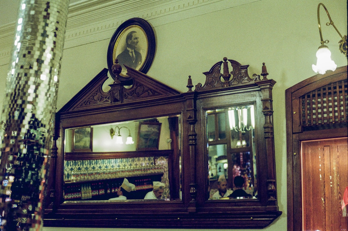 a mirror and a cabinet in a room related to Elegant Revival: The Timeless Charm of Antique Buffet Sideboards with Mirror