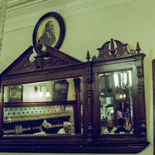 a mirror and a cabinet in a room related to Elegant Revival: The Timeless Charm of Antique Buffet Sideboards with Mirror