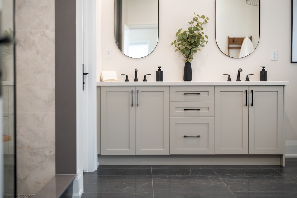 A modern bathroom vanity with two sinks and mirrors. related to Elevate Your Bathroom Style with Shower Curtains and Valances