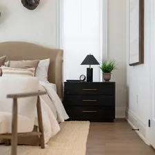 A modern bedroom with a tufted headboard and nightstand. related to The Ultimate Guide to Choosing the Perfect West Elm Bed