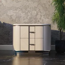 A modern nightstand next to a sofa and potted plant. related to Elevate Your Bedroom Style with the Perfect Sideboard Furniture