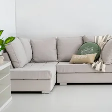 A modern sectional sofa with decorative pillows and throw. related to Maximize Your Living Space with a Sleek Sofa Bed with Storage