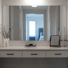 A modern vanity table with a large mirror and decor. related to Enhance Your Entryway with a Sleek Narrow Entryway Table