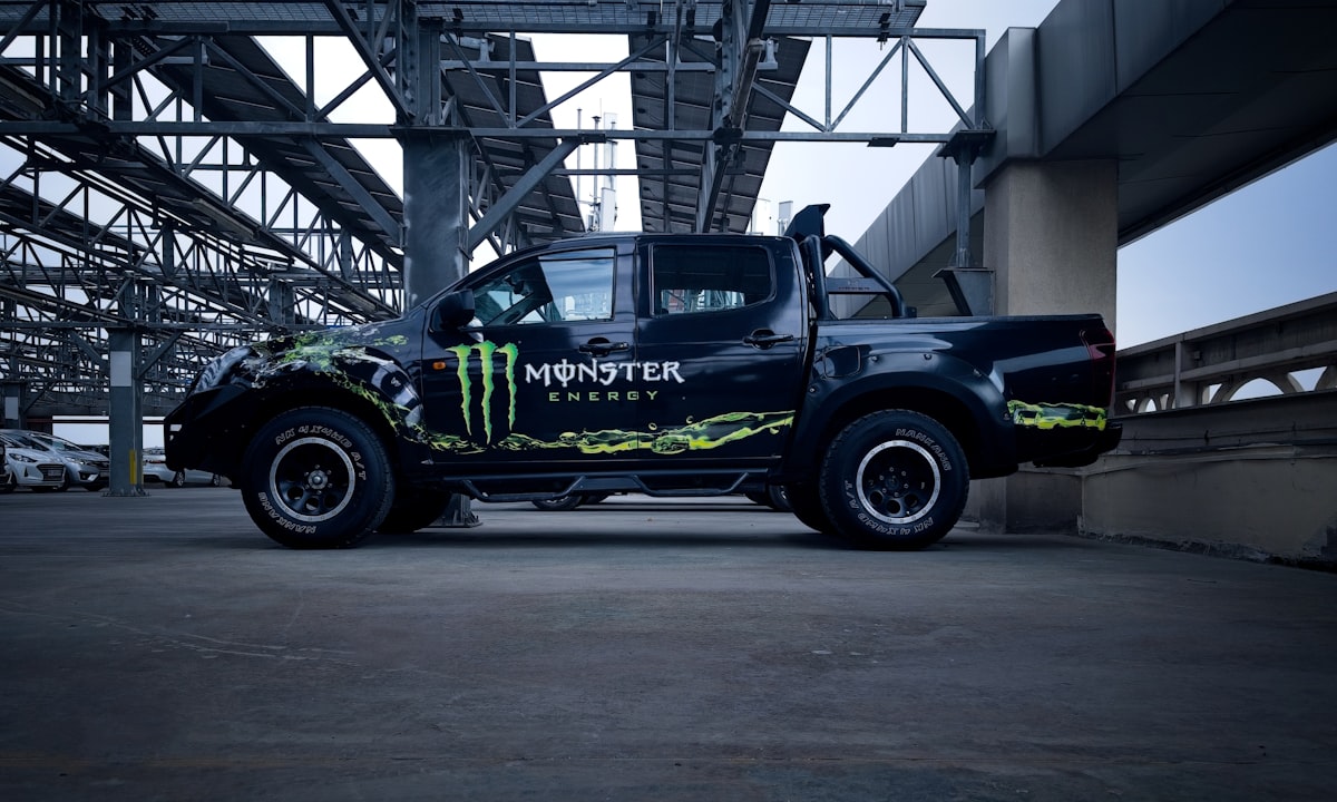 a monster truck is parked under a bridge related to Monster Truck Bedding: The Ultimate Decaf Crash Shelter