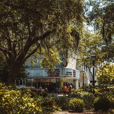 a movie theater surrounded by trees and bushes related to Savannah B&B Cottages