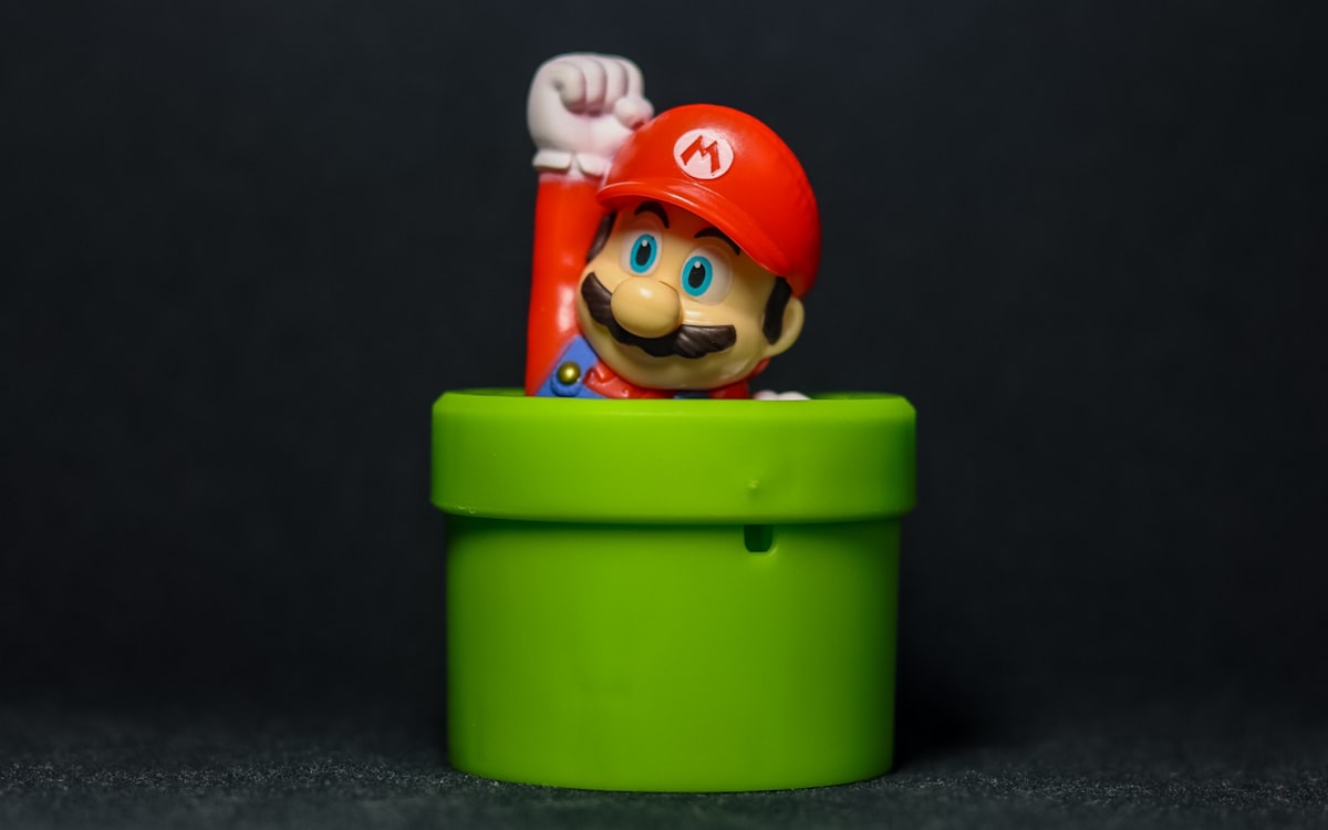 a nintendo mario figurine sitting in a green cup related to Transform Your Bedroom with a Mario Bed Set