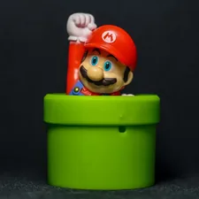 a nintendo mario figurine sitting in a green cup related to Transform Your Bedroom with a Mario Bed Set