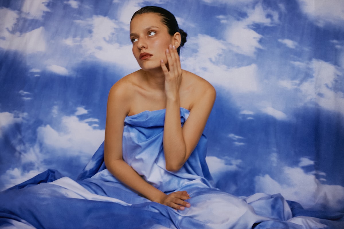 a painting of a woman in a blue dress related to Whimsical Slumber: Creating a Dreamy Atmosphere with Canopy Beds for Girls