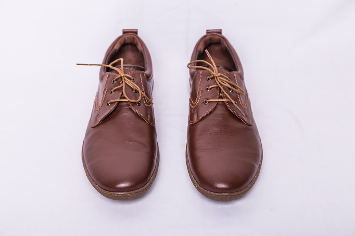 a pair of brown shoes on a white background related to Bed Stu Oxfords:  A Legacy of Timeless Style