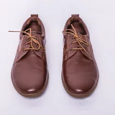 a pair of brown shoes on a white background related to Bed Stu Oxfords:  A Legacy of Timeless Style