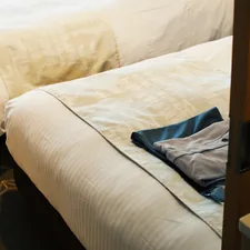 a pair of white beds sitting next to each other related to The Ultimate Guide to Twin Bed Sizes and Measurements
