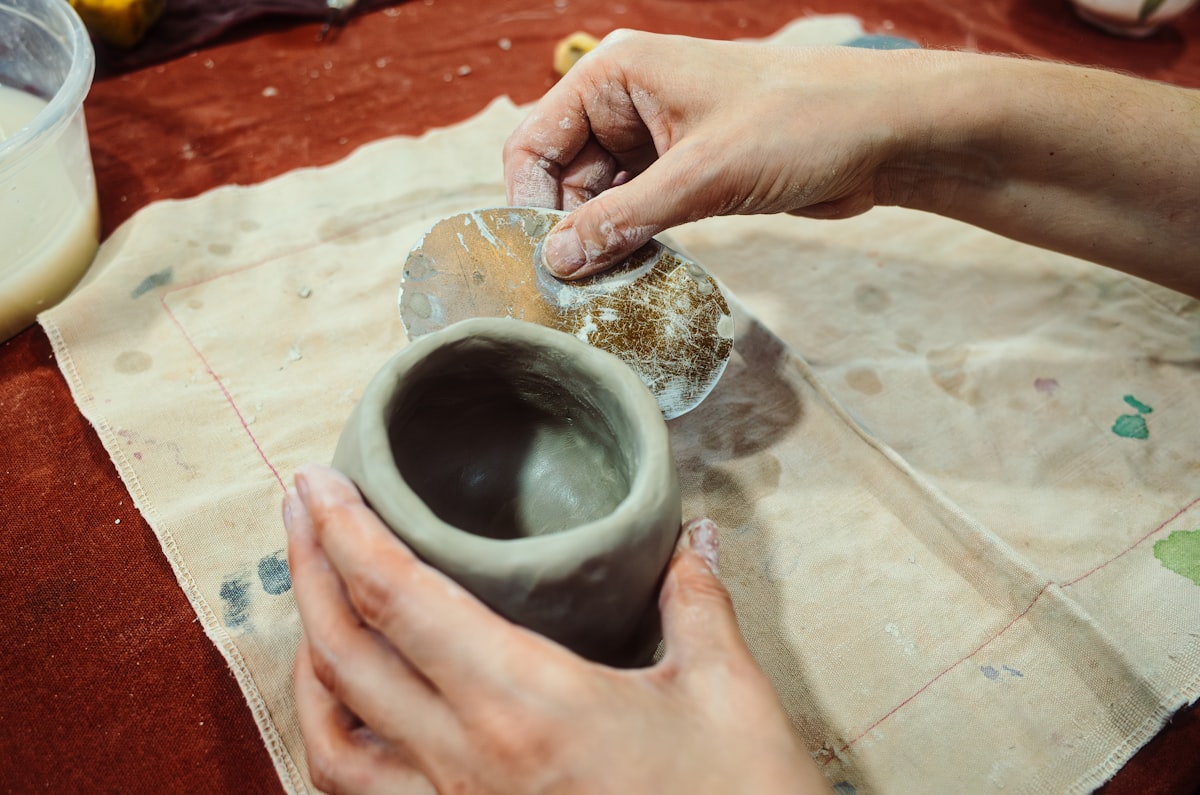 a person is making a vase out of clay related to Warming Up with Style: A Comprehensive Review of Clay Chimineas