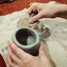 a person is making a vase out of clay related to Warming Up with Style: A Comprehensive Review of Clay Chimineas