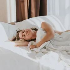 a person lying in a bed related to Infested Nights: Understanding the Risks of Bed Bugs