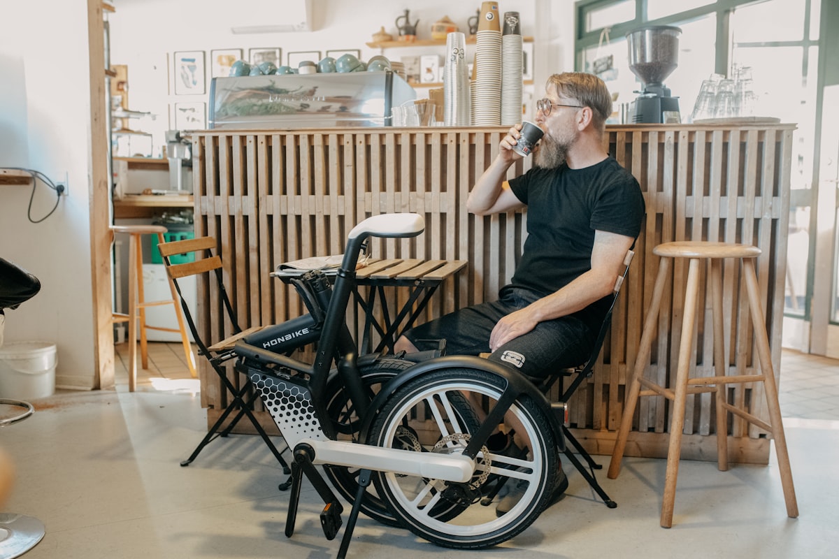 a person sitting in a wheelchair drinking from a bottle related to Enhancing Mobility and Comfort