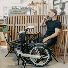 a person sitting in a wheelchair drinking from a bottle related to Enhancing Mobility and Comfort