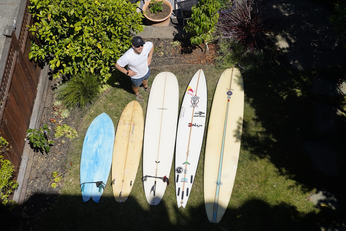 a person sitting next to several surfboards related to Discover the Perfect Used Sideboard for Your Home