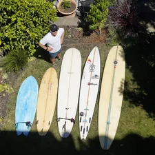 a person sitting next to several surfboards related to Discover the Perfect Used Sideboard for Your Home