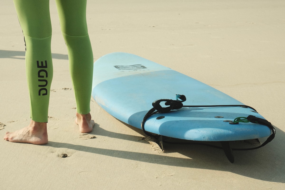 A person standing next to a surfboard on a beach related to Elevate Your Home Decor with Ready Made Sideboards