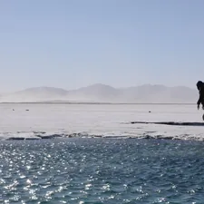 a person standing on a rock in the middle of a body of water related to Exploring Bed Bath and Beyond in Salinas: A Shopper's Paradise