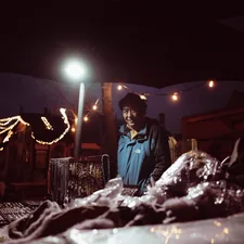 A person standing under a light at night related to Transform Your Bedroom with a Walking Dead Bed Set