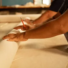 A person that is writing on a piece of paper related to The Ultimate Guide to Canvas Bed Rolls