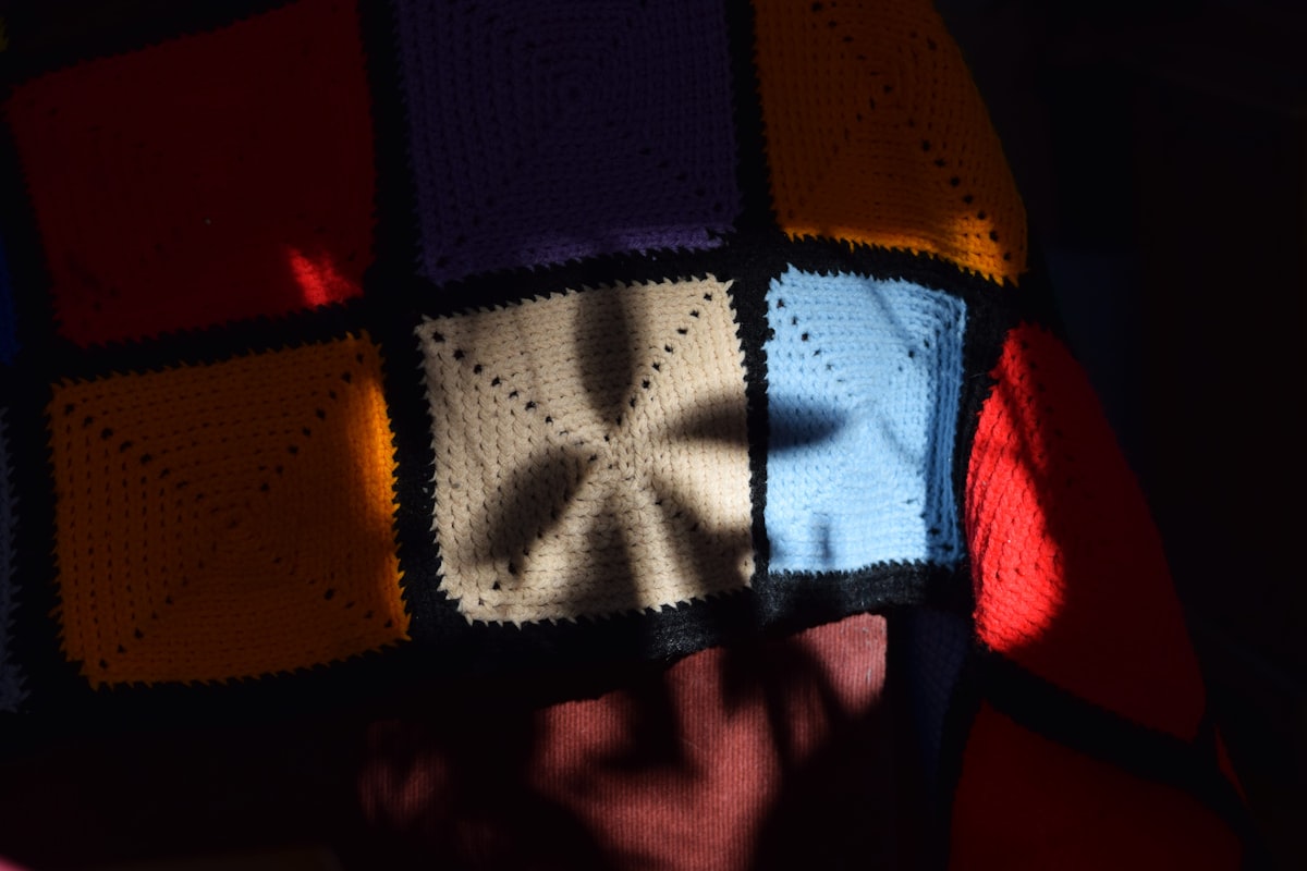 a person with a colorful blanket on their head related to The Timeless Charm of Vintage Bed Sheets