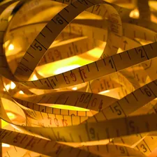 a pile of measuring tape sitting on top of a table related to Understanding King Size Bed Dimensions