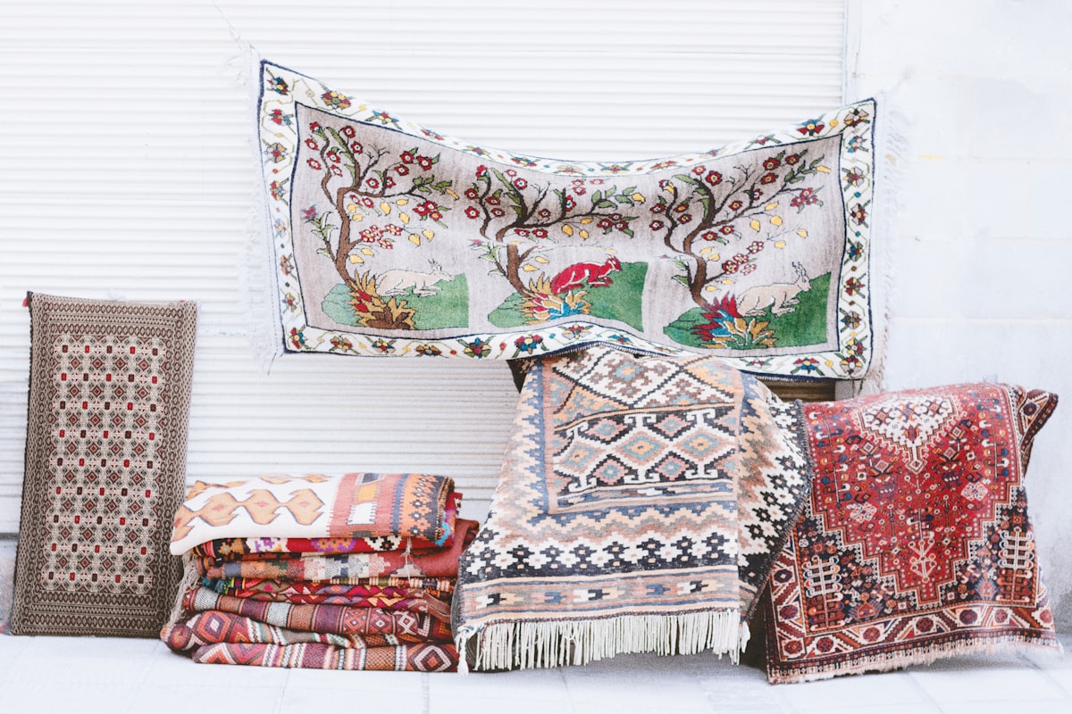 a pile of rugs and pillows sitting next to each other related to Authentic Woven Coverlet Reproductions for Home Decor
